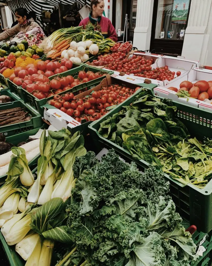 Fresh local vegetables and greens on display at a farmers market