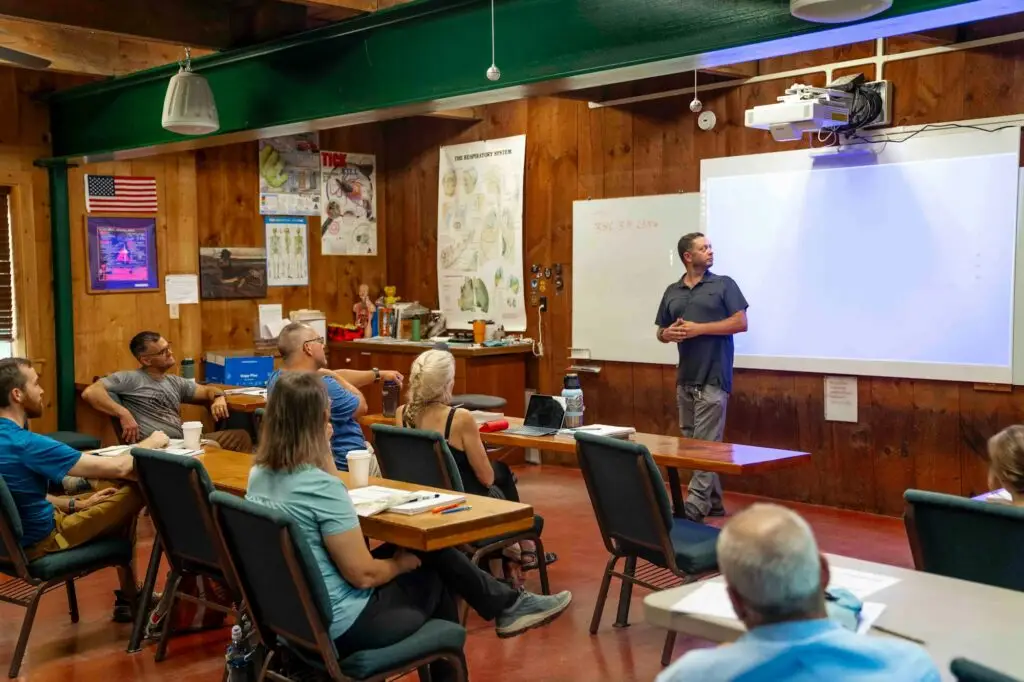 A speaker presenting to an audience in a classroom setting